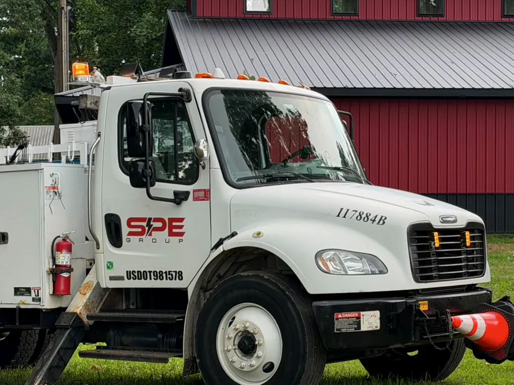 Cab of an SPE Group truck with the door logo and unit number